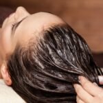 Cosmetologist massaging hair on the head of the woman. Spa treat